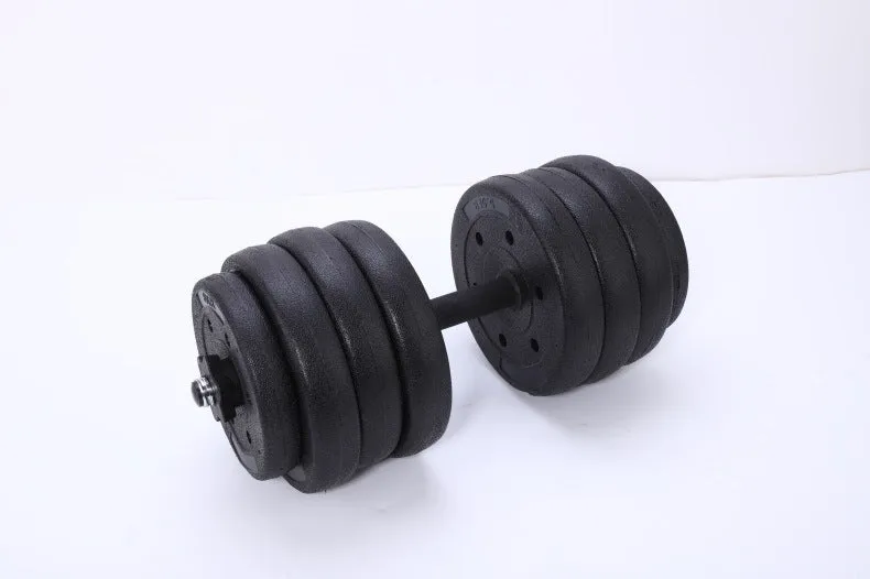 Pair of black rubber coated round head dumbbells 10kg each on a gym floor with indoor fitness equipment