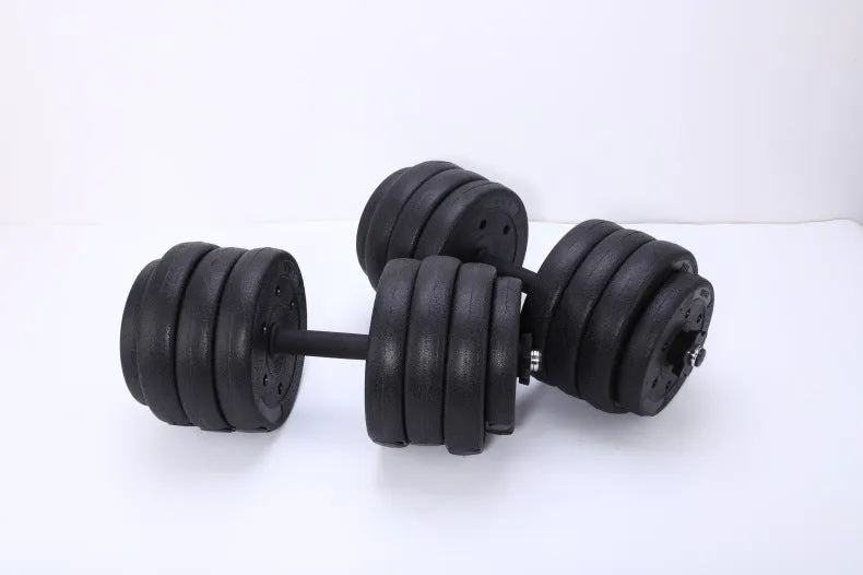 Pair of black rubber coated round head dumbbells 10kg each on a gym floor with indoor fitness equipment