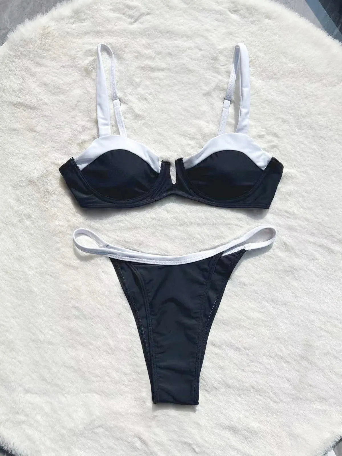 Black women's low waist bikini swimsuit with stitching split detail on brief style