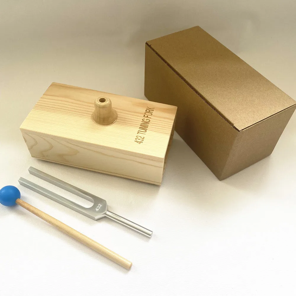 Aluminium alloy 432Hz tuning fork and portable speaker kit on a kraft paper box.