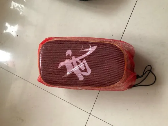 Muay Thai foot target pad in PU leather with black and blue colour scheme showing curved face and Velcro strap