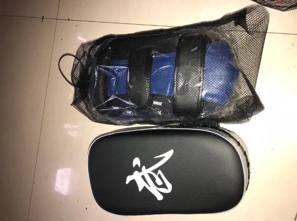Muay Thai foot target pad in PU leather with black and blue colour scheme showing curved face and Velcro strap
