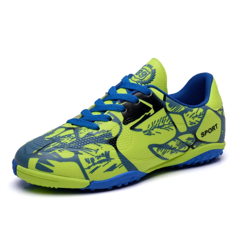 Red low-top soccer shoes with synthetic leather upper and spike outsole on natural grass