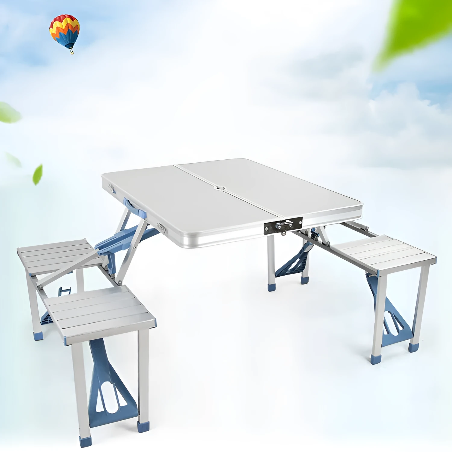 Outdoor folding table and chair set in aluminium alloy with four chairs, expanded on grass, silver gray colour, showing 85.5cm desktop and umbrella hole