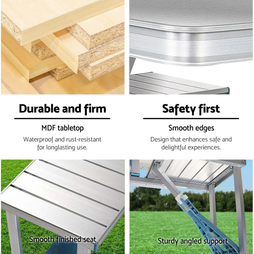 Outdoor folding table and chair set in aluminium alloy with four chairs, expanded on grass, silver gray colour, showing 85.5cm desktop and umbrella hole