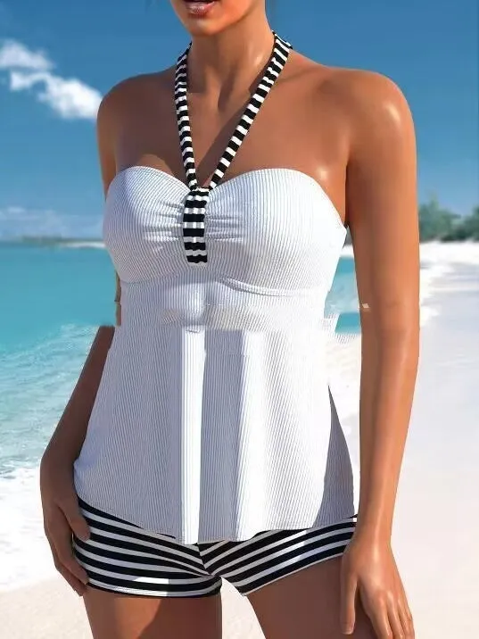 Women's off-shoulder swimsuit with black and white stripes on solid colour background