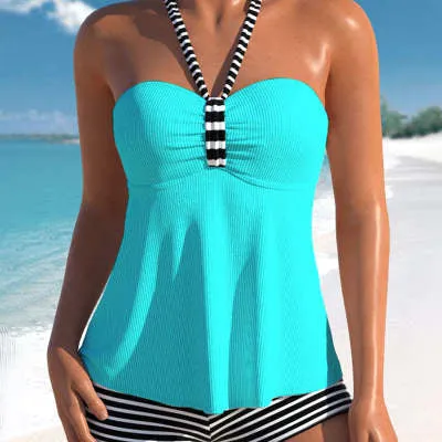 Women's off-shoulder swimsuit with black and white stripes on solid colour background