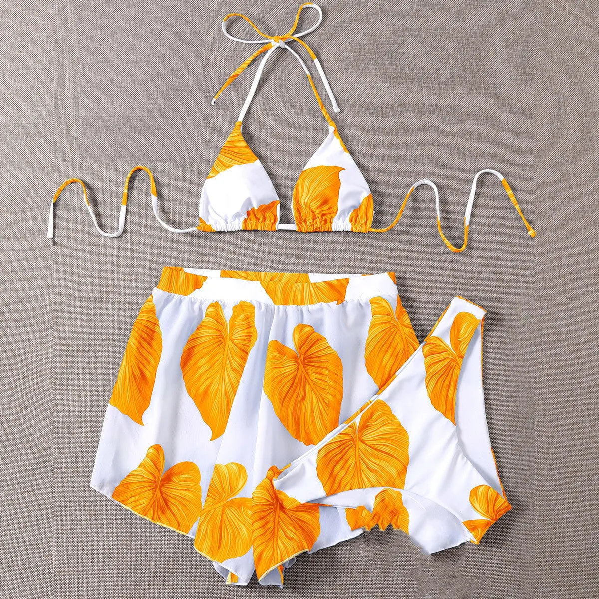 Women's adjustable three-piece bikini swimsuit in orange with printed pattern and chest pads