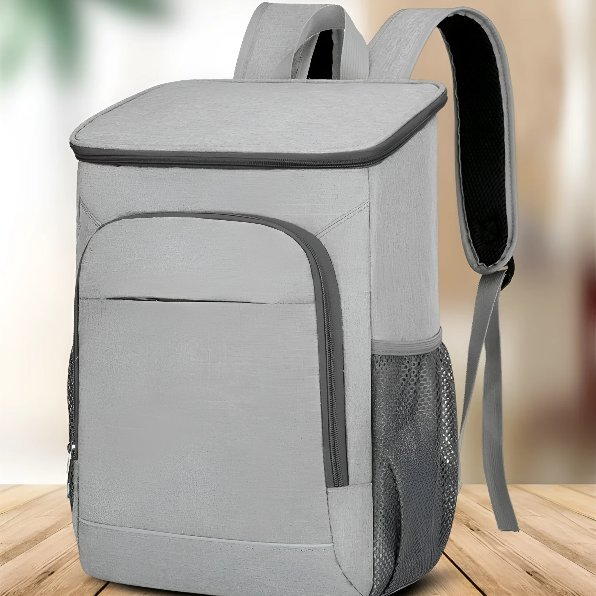 Large black outdoor thermal picnic backpack with curved shoulder straps on a gray background.