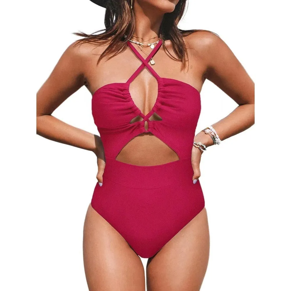 Woman wearing a solid colour cross-back halter one-piece swimsuit on the beach.