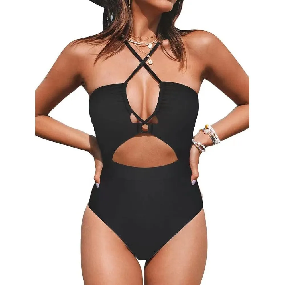 Woman wearing a solid colour cross-back halter one-piece swimsuit on the beach.