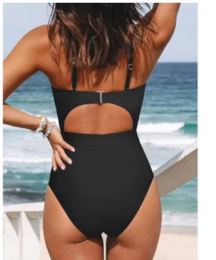 Woman wearing a solid colour cross-back halter one-piece swimsuit on the beach.