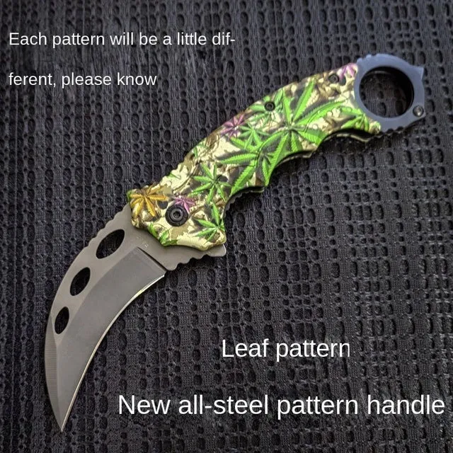 Folding claw knife with grey titanium blade and sour branch wood handle on a surface