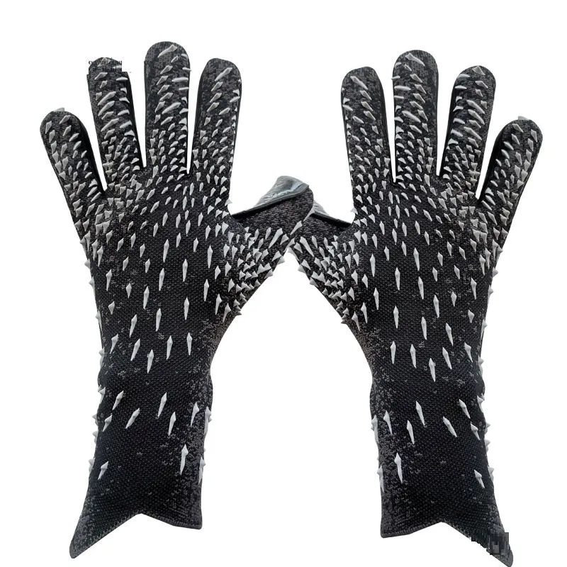 Childrens rubber goalkeeper training gloves in red, black, green and orange on green grass
