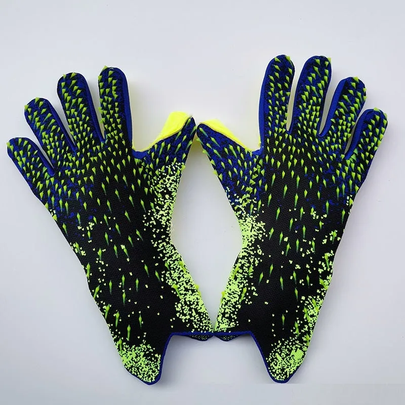 Childrens rubber goalkeeper training gloves in red, black, green and orange on green grass