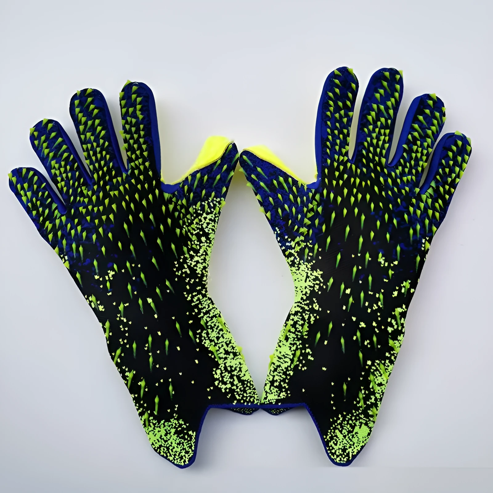 Childrens rubber goalkeeper training gloves in red, black, green and orange on green grass