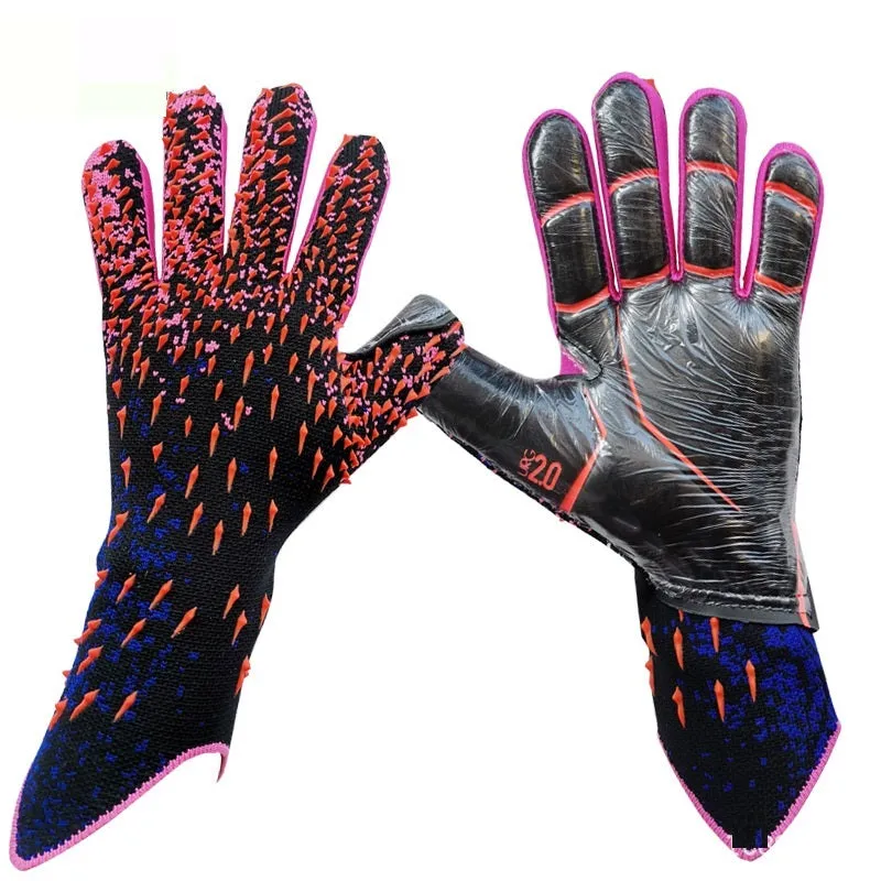 Childrens rubber goalkeeper training gloves in red, black, green and orange on green grass