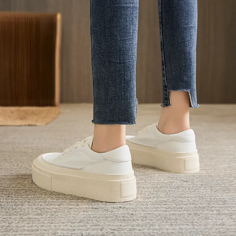 Women's black embossed cowhide leather platform sports shoes with white rubber sole and lace-up front.
