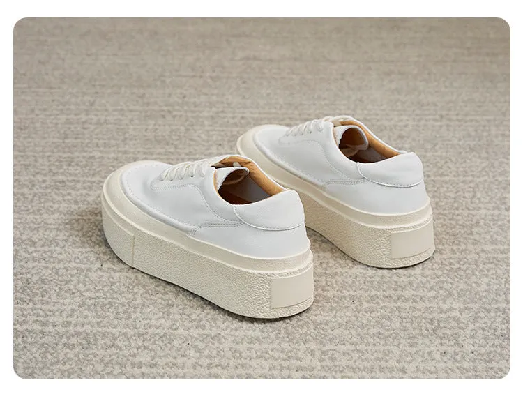 Women's black embossed cowhide leather platform sports shoes with white rubber sole and lace-up front.