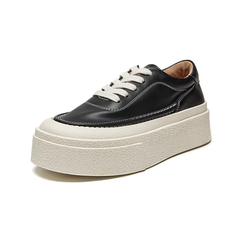 Women's black embossed cowhide leather platform sports shoes with white rubber sole and lace-up front.