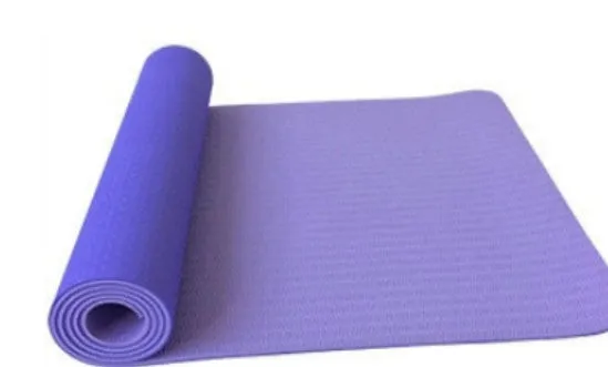 6mm TPE beginner yoga mat in black, rolled on wooden floor with textured non-slip surface visible