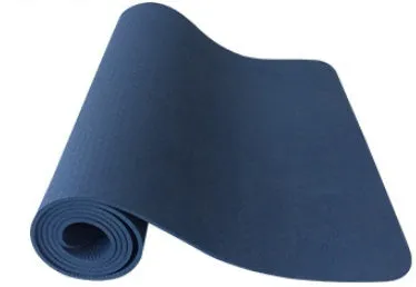 6mm TPE beginner yoga mat in black, rolled on wooden floor with textured non-slip surface visible