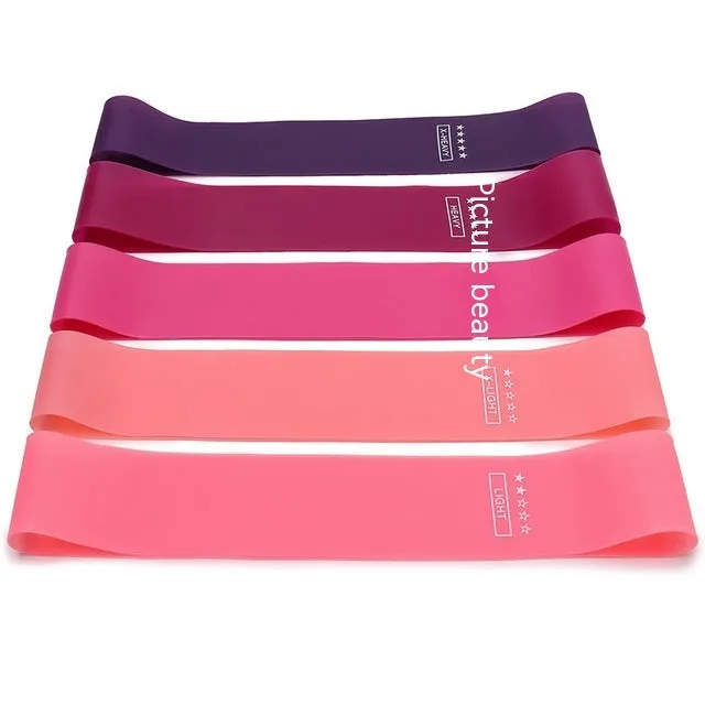Five colour-coded TPE yoga tension straps with force marks arranged by thickness from 0.5mm to 1.1mm