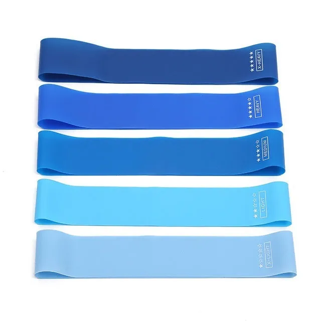 Five colour-coded TPE yoga tension straps with force marks arranged by thickness from 0.5mm to 1.1mm