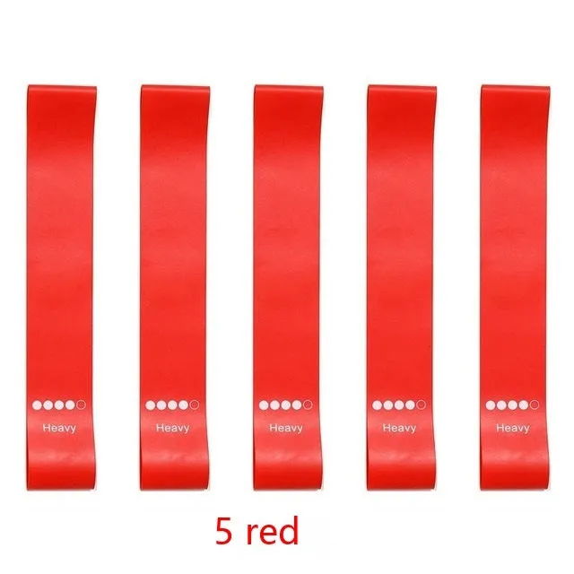 Five colour-coded TPE yoga tension straps with force marks arranged by thickness from 0.5mm to 1.1mm