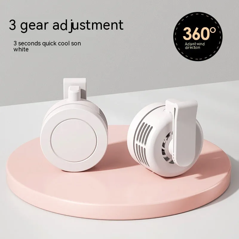 Green wrist hanging personal fan with light and USB charging port on a compact ABS and silicone body.