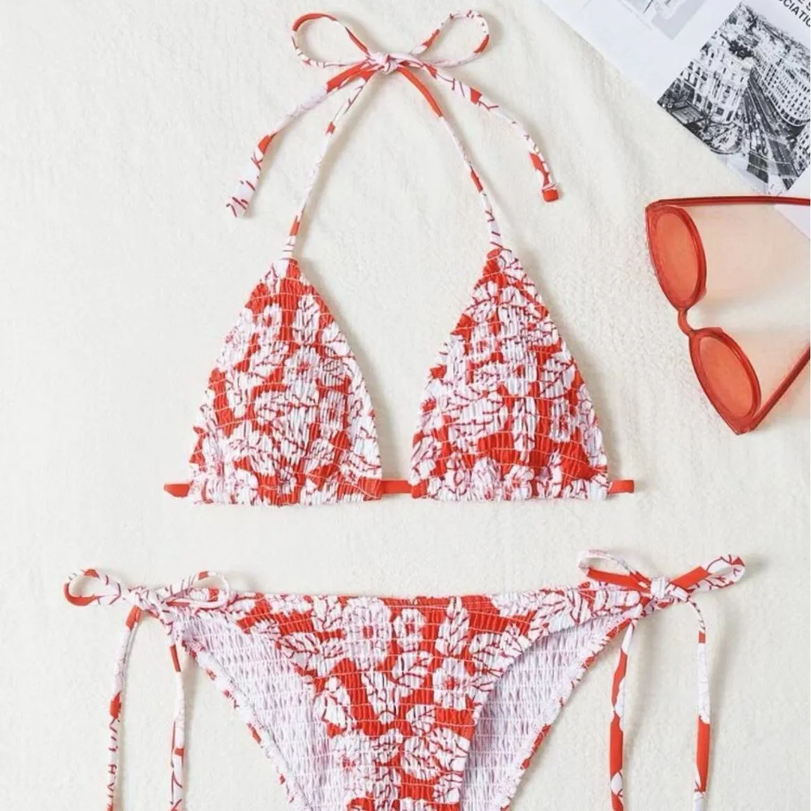 Women's floral print halter swimsuit briefs in light blue on a mannequin.