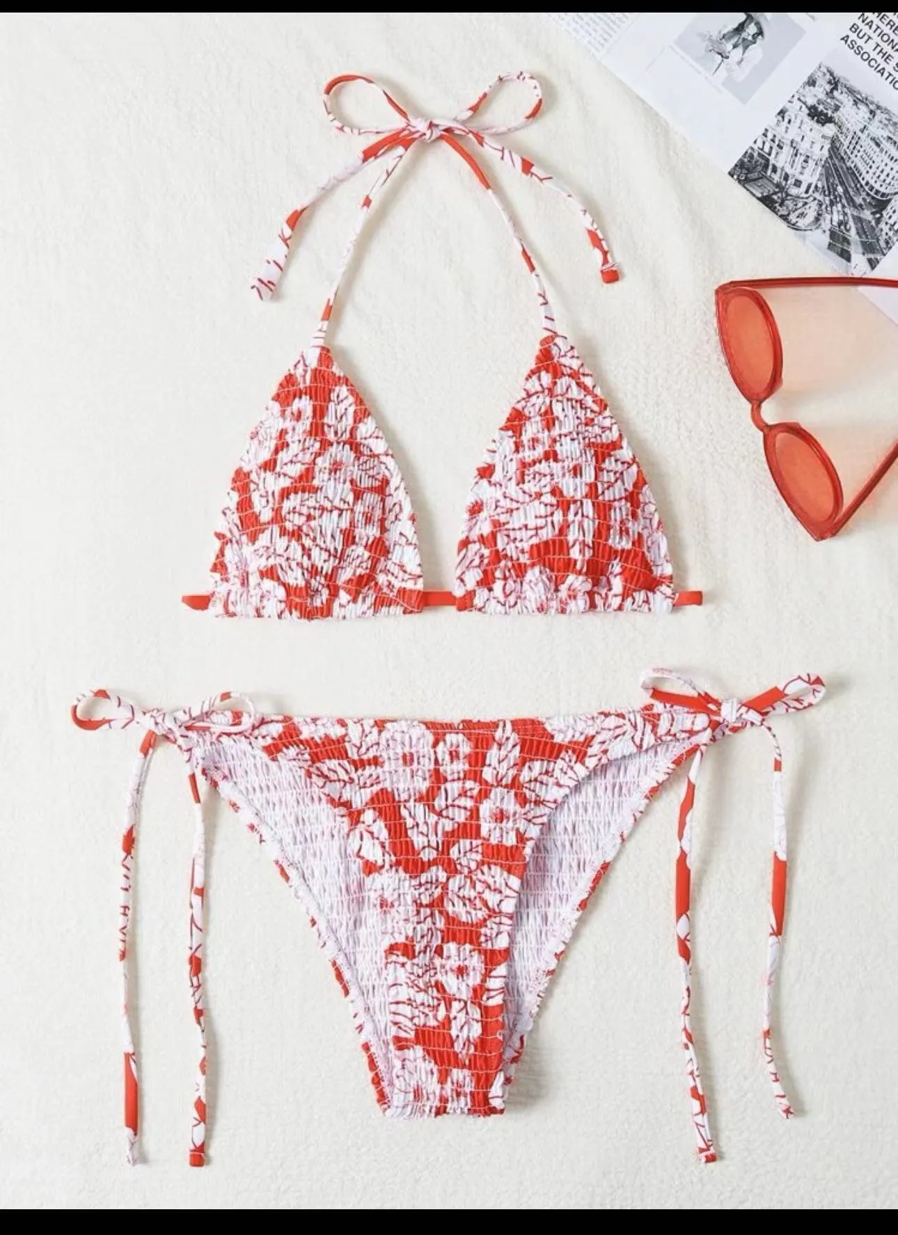 Women's floral print halter swimsuit briefs in light blue on a mannequin.