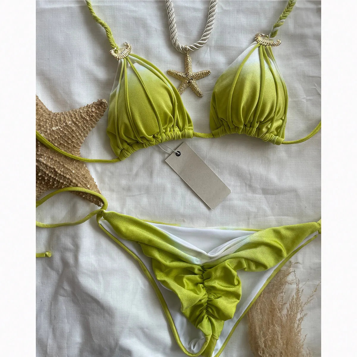 Tie-dyed bikini set in green with high-waist backless briefs on a woman by the seaside