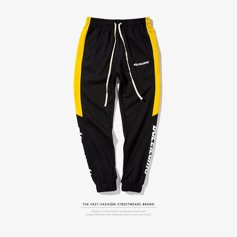 Spring men's casual slim fit sweatpants in black and white printed polyester with zippered pockets and drawstring waist