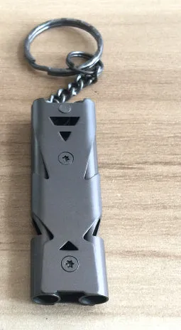 Compact keychain whistle in black and silver with keychain attachment for portable emergency signalling