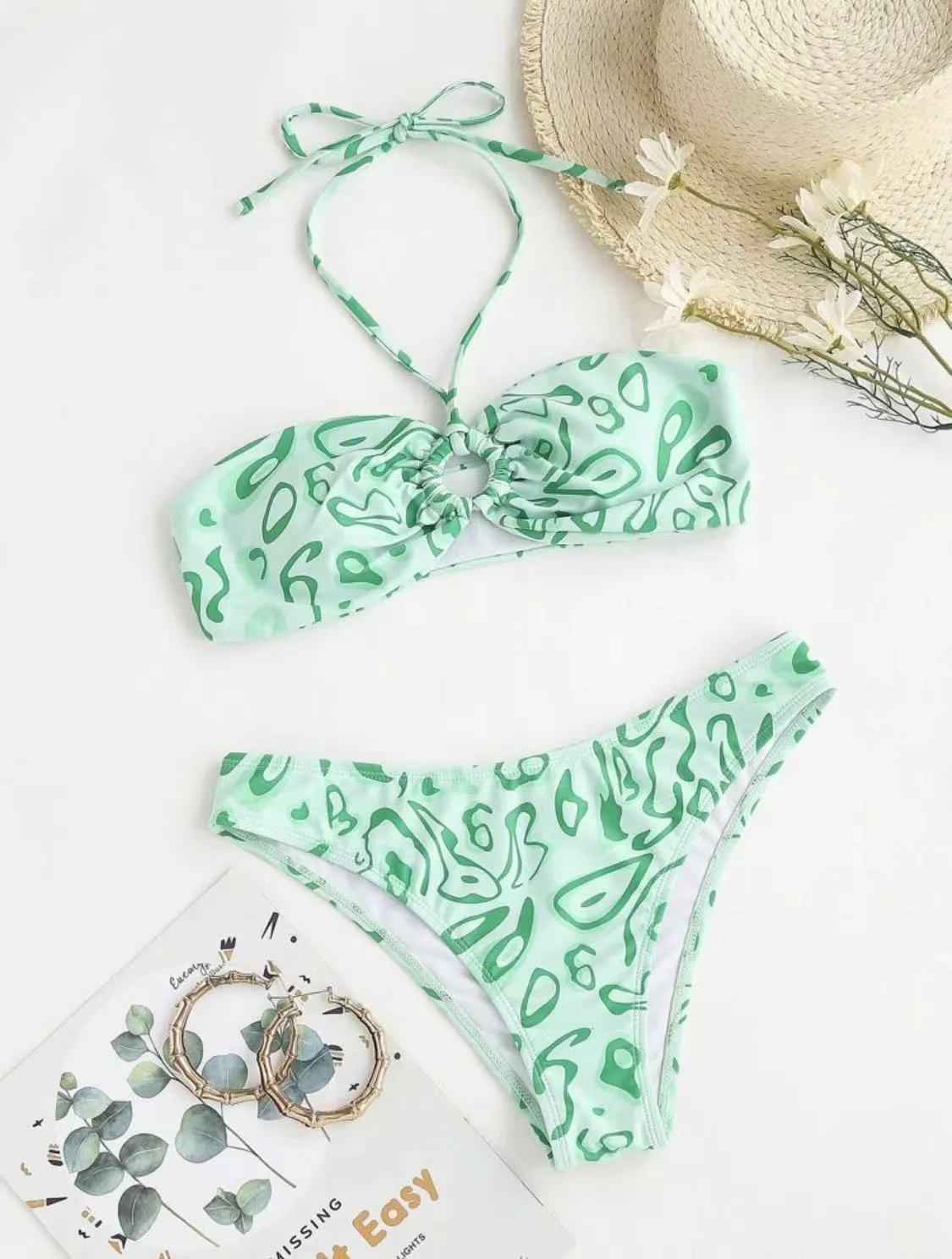Women's blue floral bandeau bikini swimsuit with split style design on mannequin