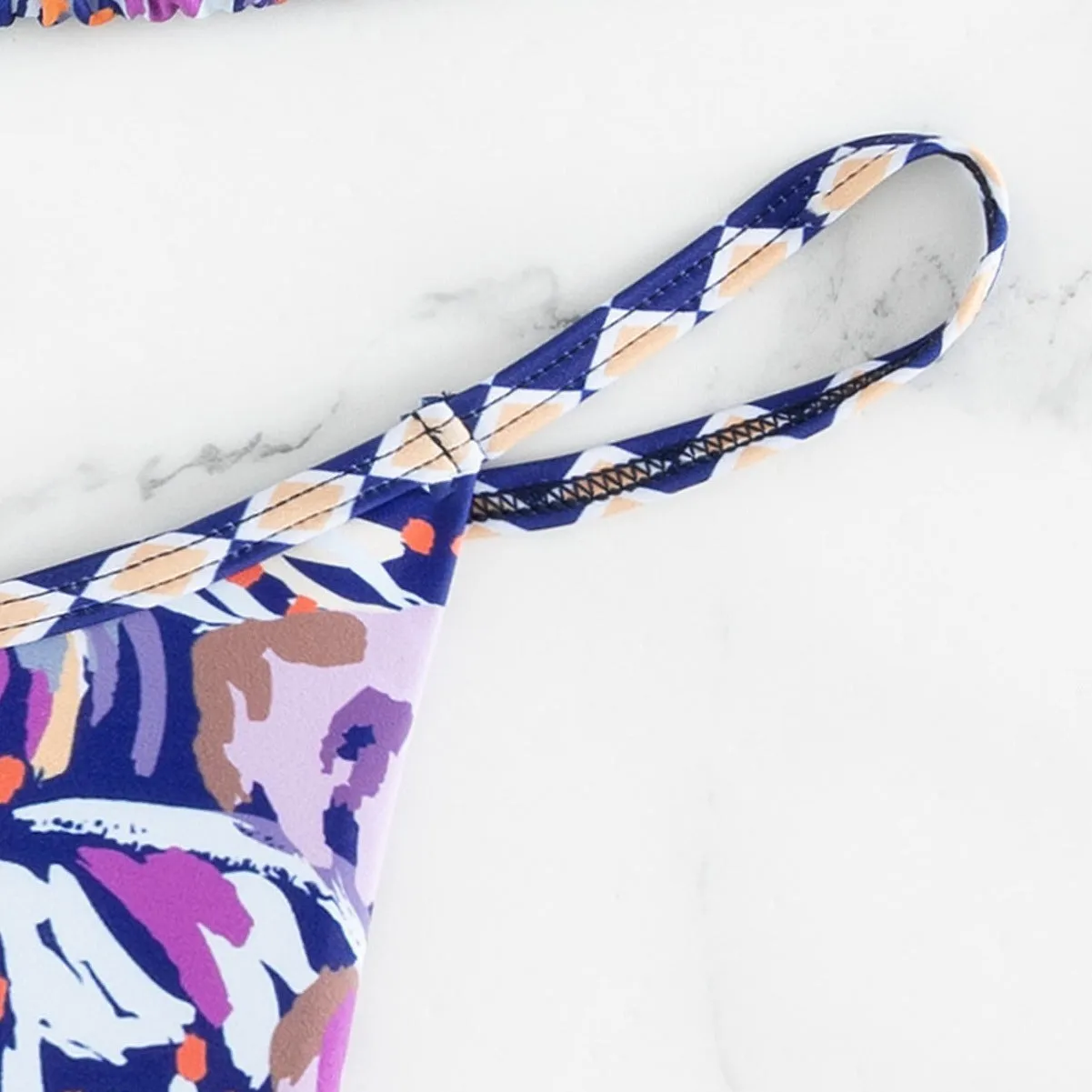 Women's floral print triangle bikini with tie-back and split-front polyester briefs.
