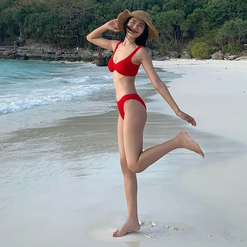 Women's simple split bikini vacation swimsuit in red polyester, sleeveless, shown on a model, available in sizes S M L