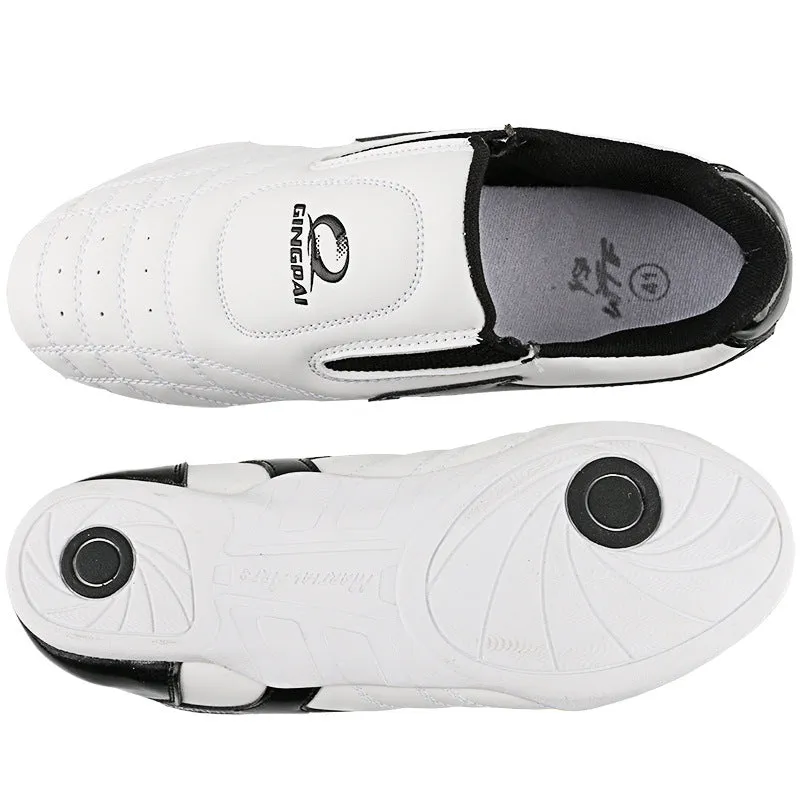 Black and white children's Sanda Taekwondo martial arts shoes with a soft sole and widened fit.
