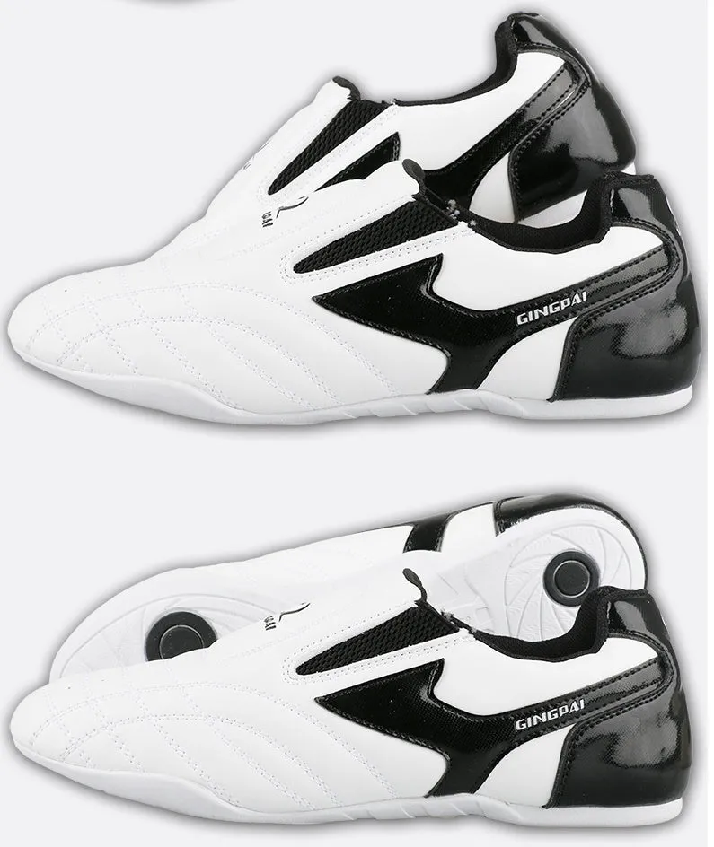 Black and white children's Sanda Taekwondo martial arts shoes with a soft sole and widened fit.
