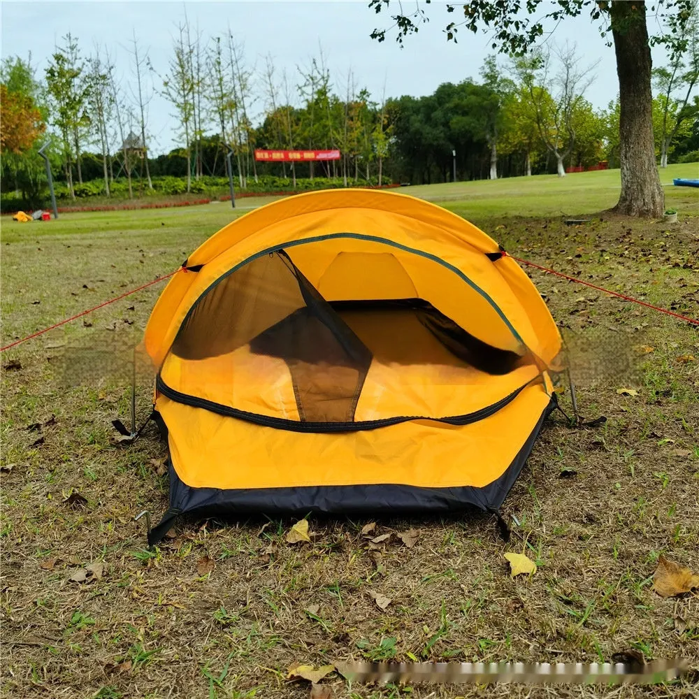 Single person sleeping bag tent in army green set up outdoors, showing rain fly and aluminium rod poles.