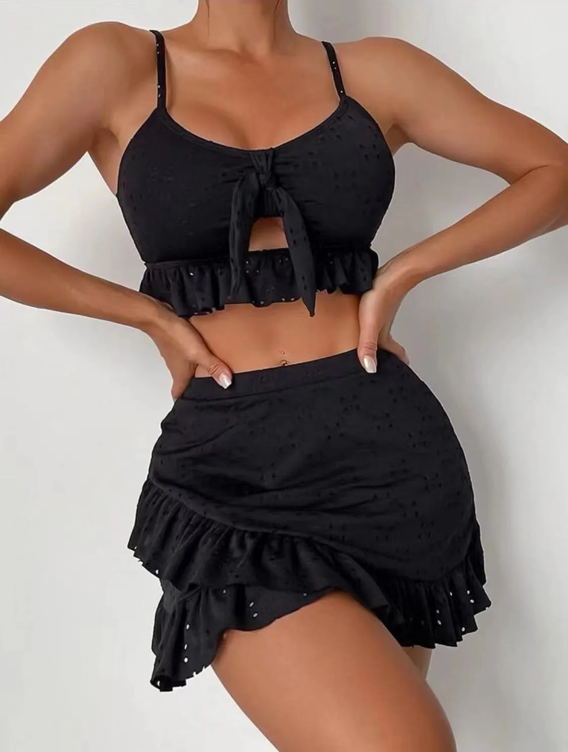 Women's solid colour split hip skirt bikini swimsuit three-piece set on a mannequin.