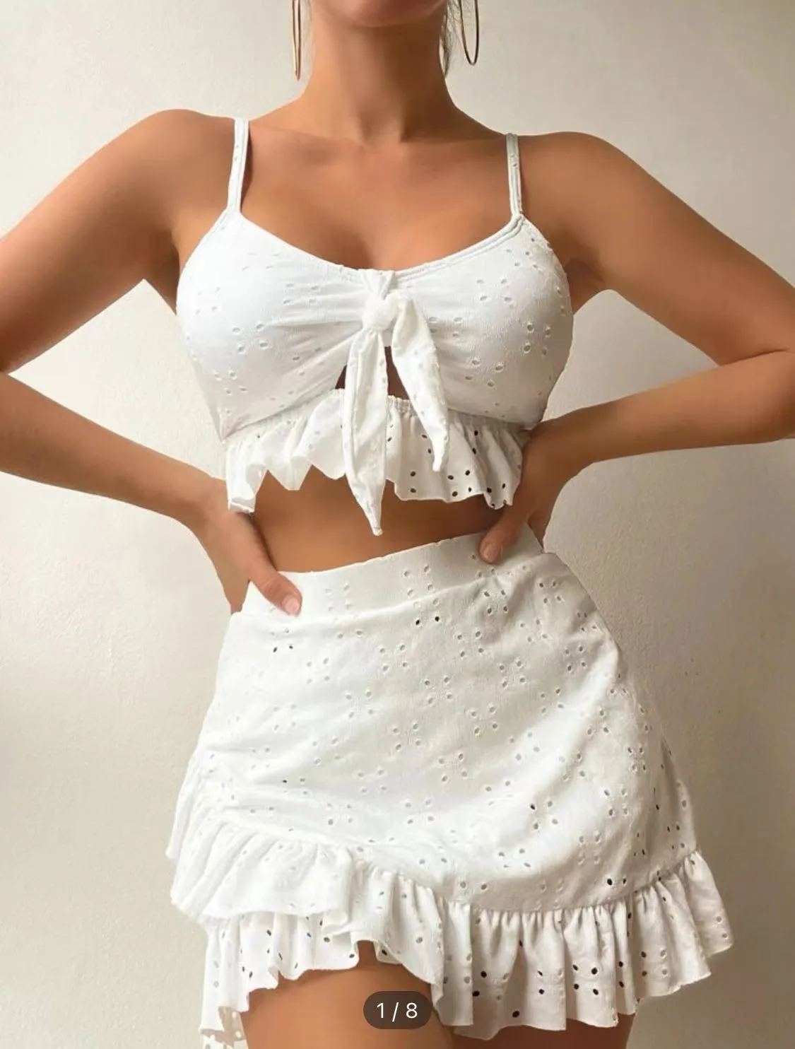 Women's solid colour split hip skirt bikini swimsuit three-piece set on a mannequin.