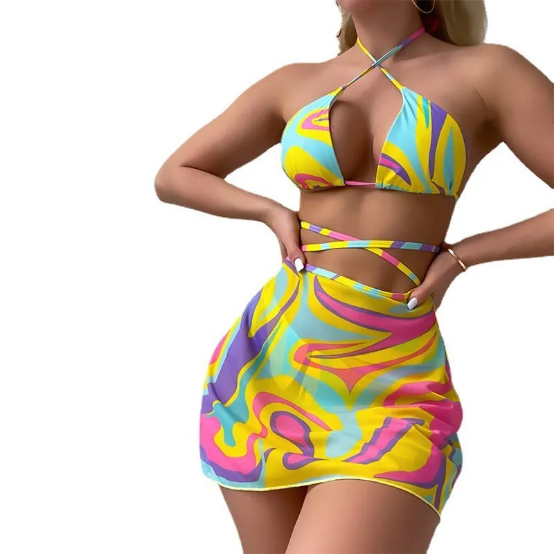 Yellow striped women's halter swimsuit with lace-up front, worn with matching skirt and shorts.