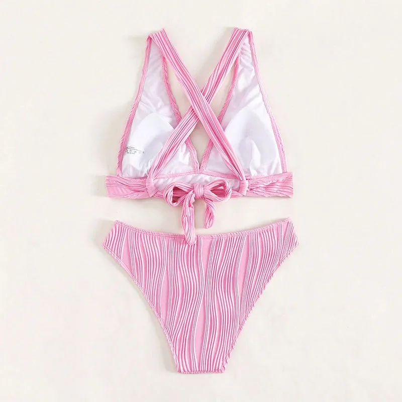 Women's pink halter strap bikini top and shorts swimsuit set on a mannequin.