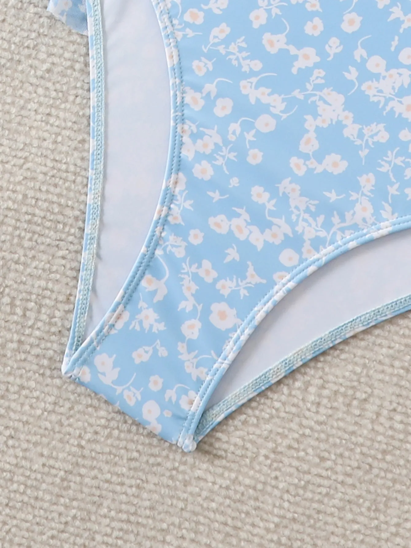Light blue floral women's swimsuit set with shoulder straps and backless design, available in sizes S to XL