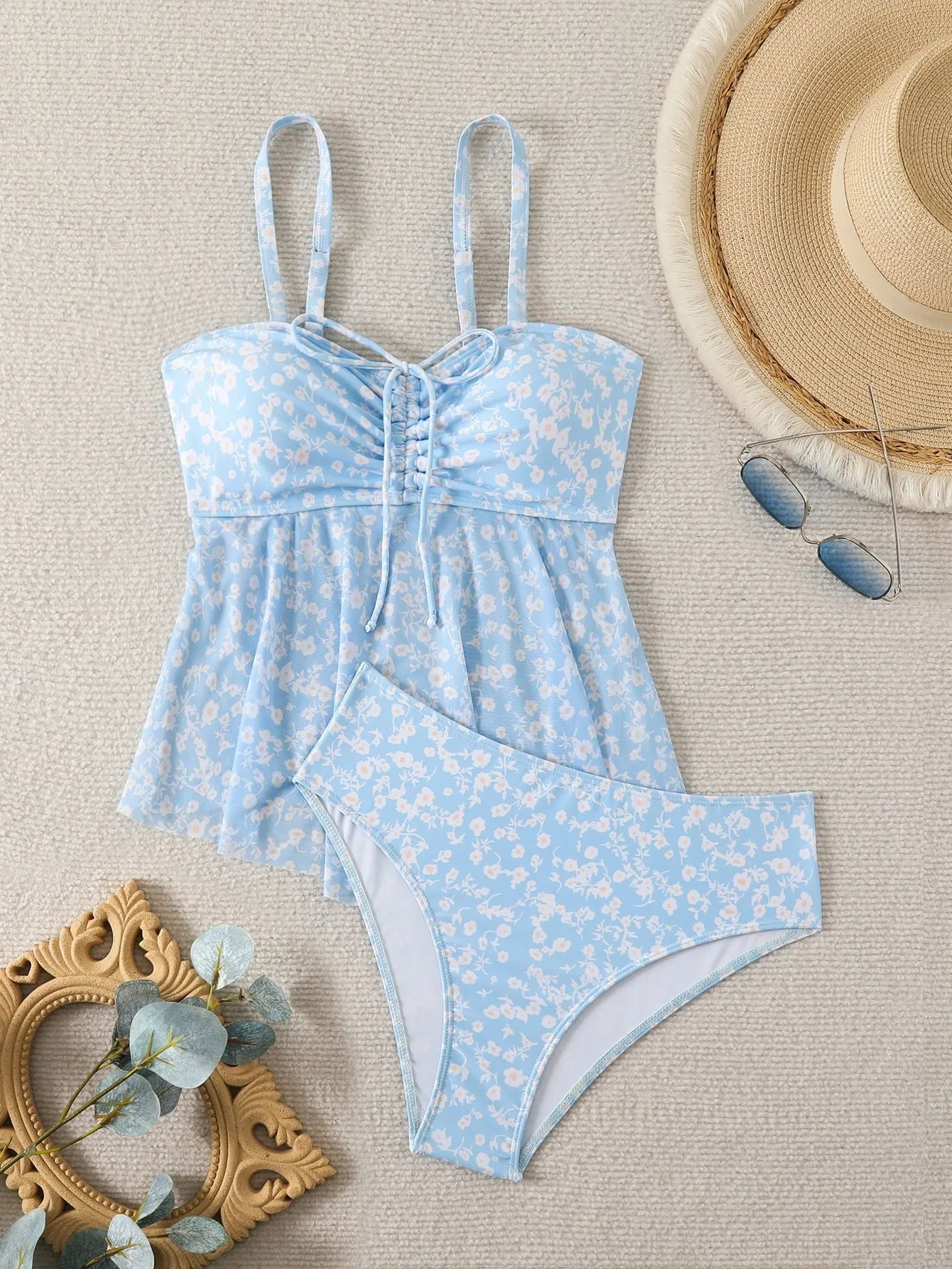 Light blue floral women's swimsuit set with shoulder straps and backless design, available in sizes S to XL