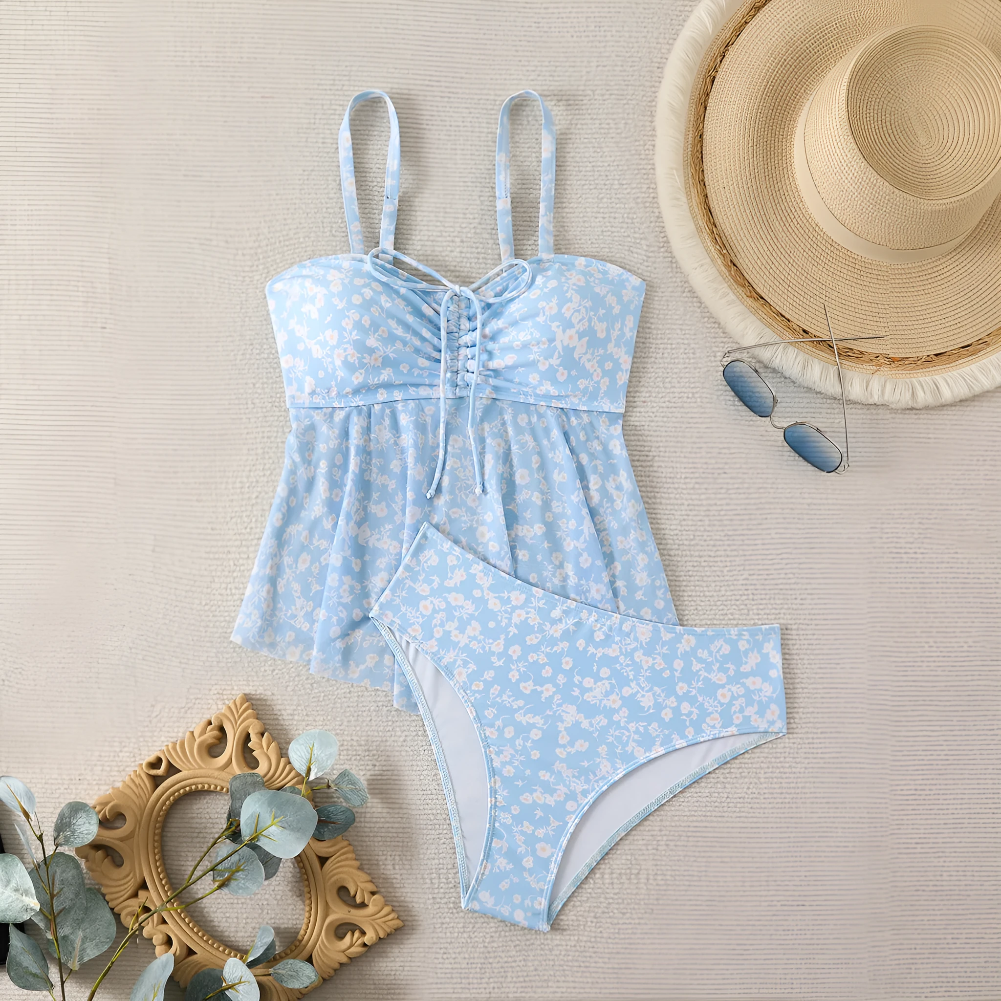 Light blue floral women's swimsuit set with shoulder straps and backless design, available in sizes S to XL