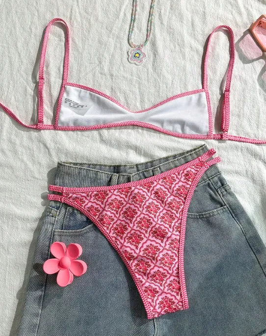 Printed pink split bikini set with exposed back and adjustable shoulder straps on woman
