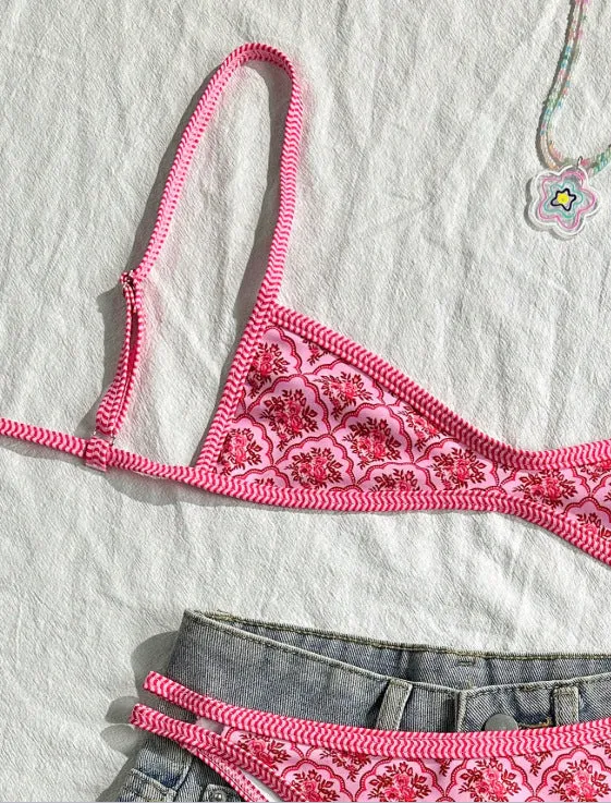 Printed pink split bikini set with exposed back and adjustable shoulder straps on woman